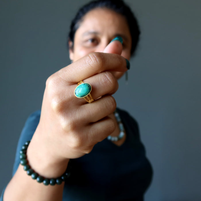 woman wearing 
gold chrysocolla ring