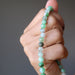 hand holding chrysoprase anklet
