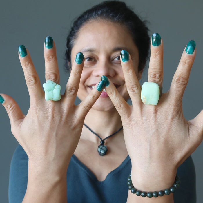 woman wearing two chrysocolla rings