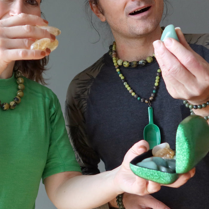 people admiring citrine and green aventurine tumbled stone set