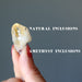 hand holding citrine point showing natural inclusions