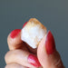 hand holding raw citrine point