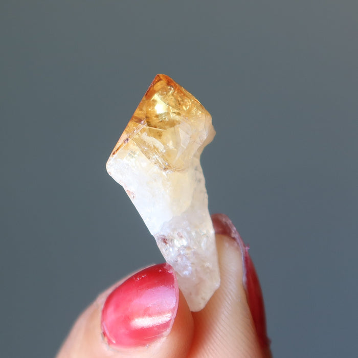 hand holding raw citrine point