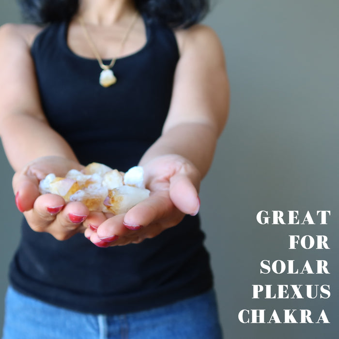 hand holding raw citrine points great for solar plexus