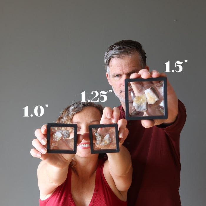 man and woman holding yellow citrine cluster pairs in suspension cases