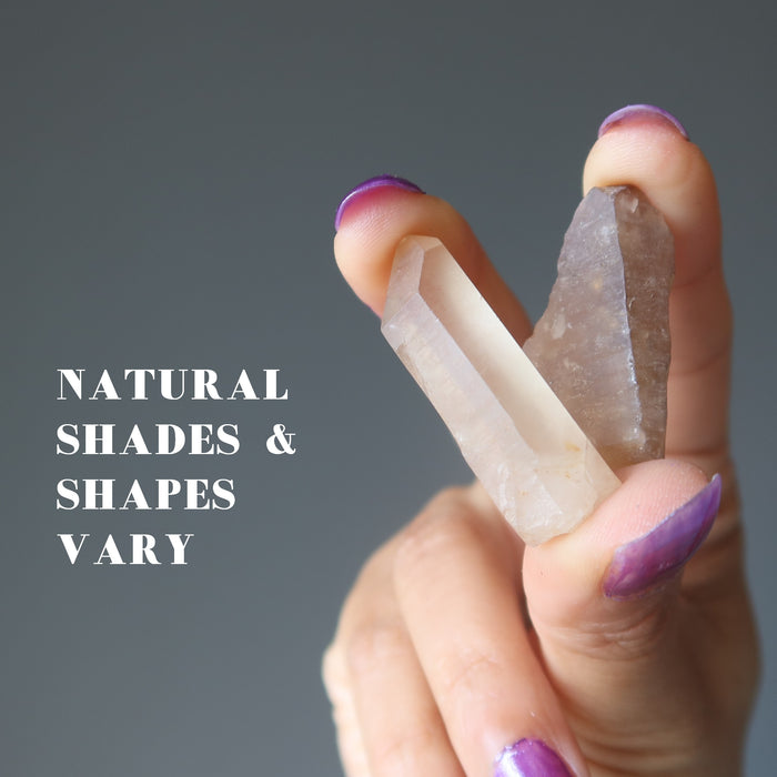 hand holding two untreated citrine to show colors vary