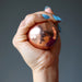 hand holding a copper alchemist sphere