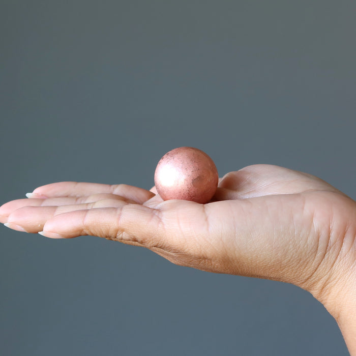 displaying Matte Copper Sphere on model palm