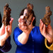 models holding coprolite dinosaur poop