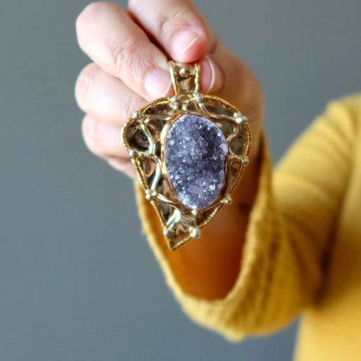 model holding 2.6 x 1.8 inches oval Druzy Amethyst Gold Leaf framed Pendant 