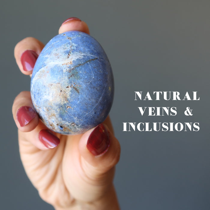 hand holding blue dumortierite crystal egg