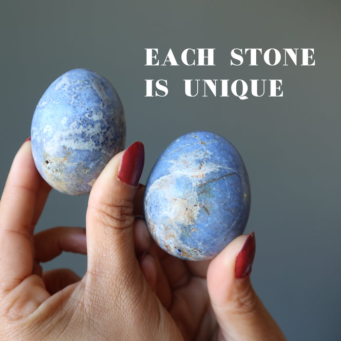 hand holding blue dumortierite crystal egg