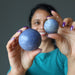 sheila of satin crystals holding blue Dumortierite Sphere on both hands