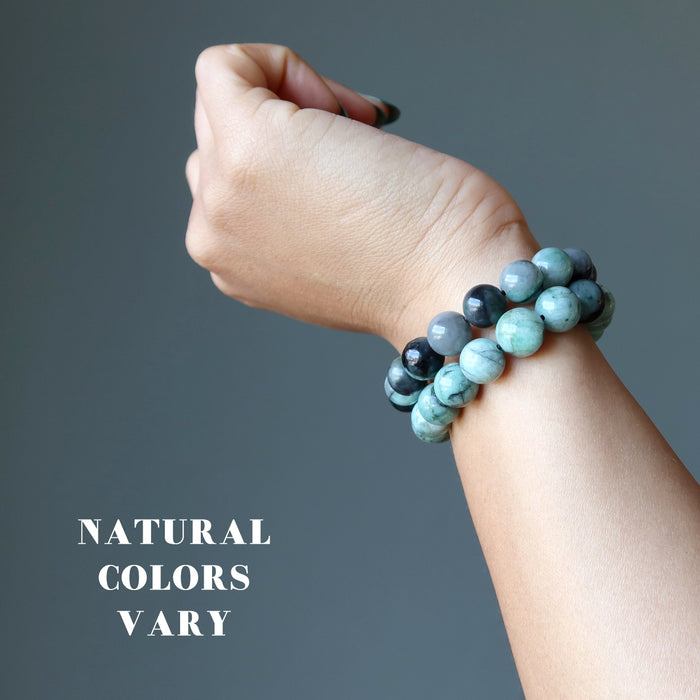 model wearing two Emerald Bracelets