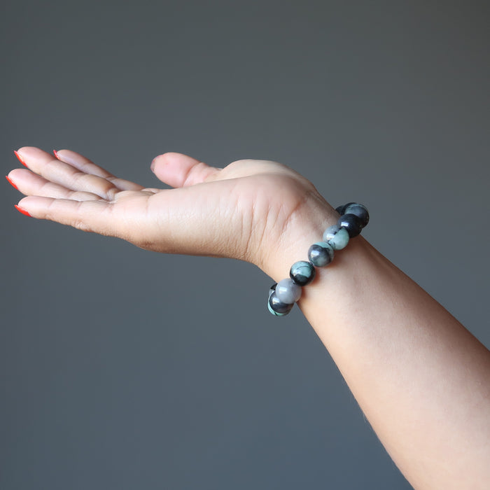 female hand modeling polished emerald stretch bracelet