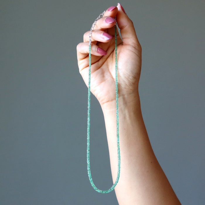 hand holding Emerald Necklace
