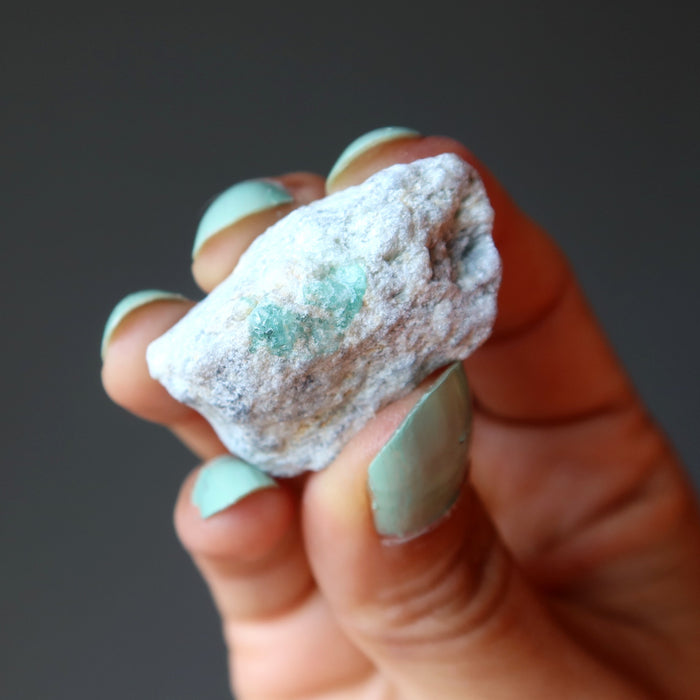 hand holding raw Emerald Cluster