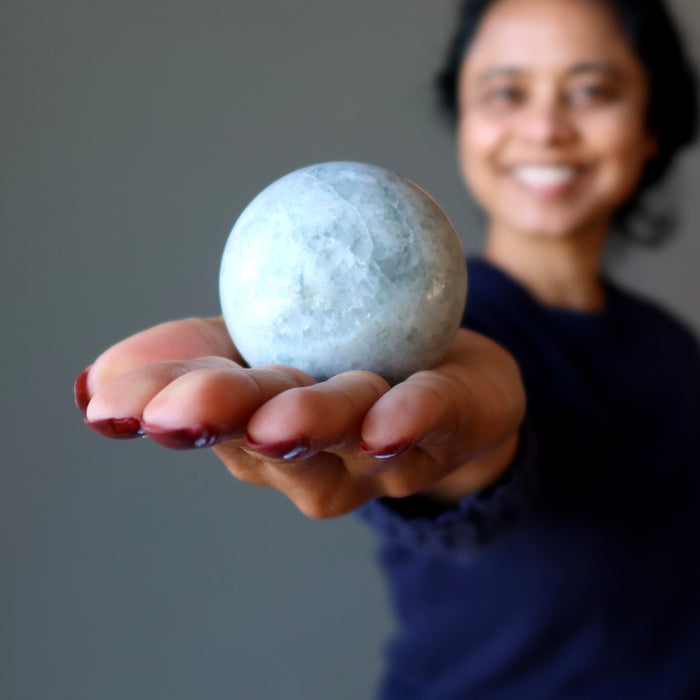 sheila of satin crystals holding holding Creamy Green Fluorite Spheres