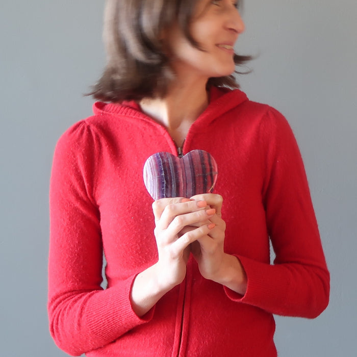 female model holding Purple Fluorite Heart