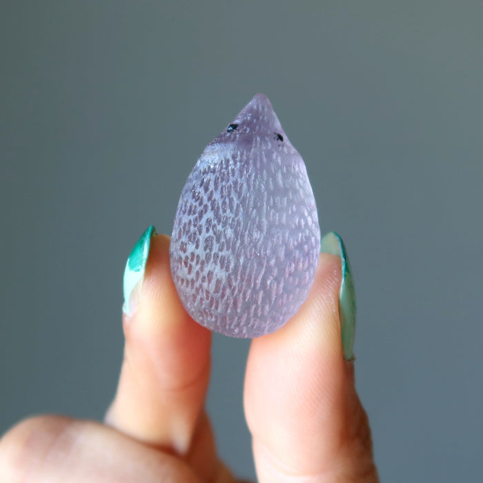 finger tips holding Rainbow Fluorite Hedgehog 