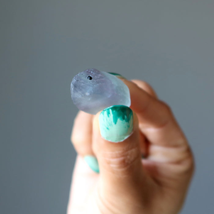 finger tips holding Rainbow Fluorite Hedgehog 