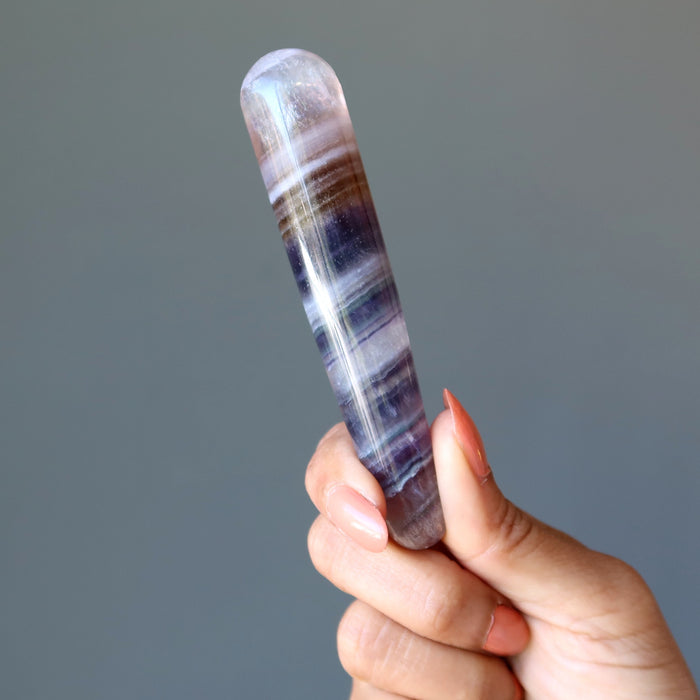 hand holding rainbow fluorite tapered massage wand
