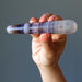 hand holding rainbow fluorite tapered massage wand