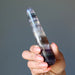 hand holding rainbow fluorite tapered massage wand