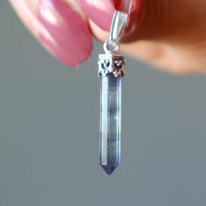 holding Purple Rainbow Fluorite Pendant on Sterling Silver