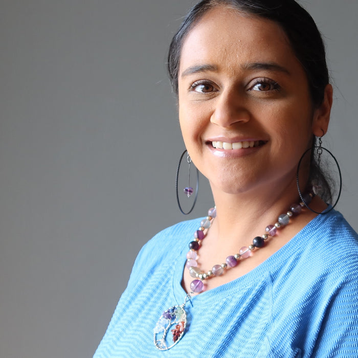 woman modeling purple fluorite heart hoop earrings