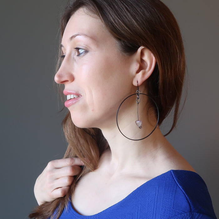 woman modeling purple fluorite heart hoop earrings