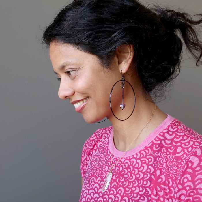 woman modeling purple fluorite heart hoop earrings