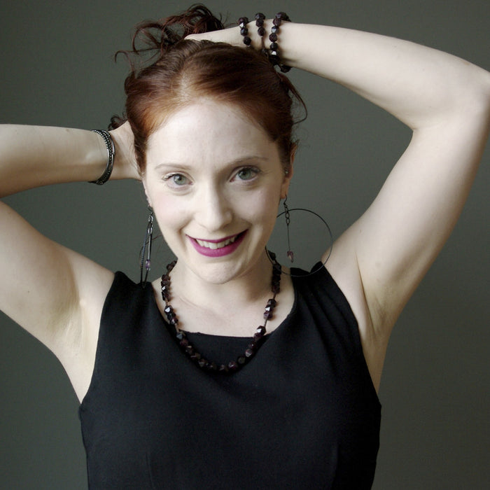 woman modeling purple fluorite heart hoop earrings