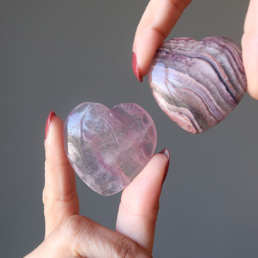 hands holding a Fluorite Heart on each hand