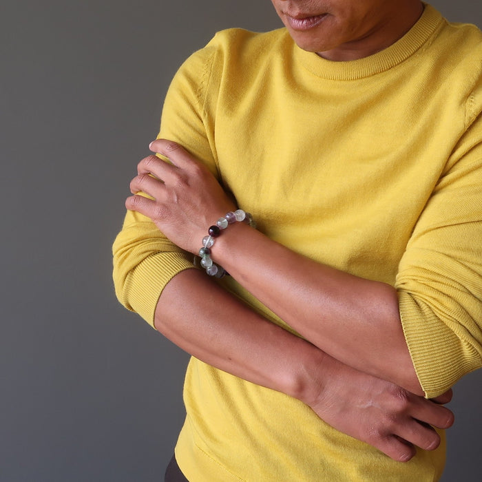 man wearing rainbow fluorite beaded stretch bracelet 