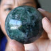 model holding green purple rainbow Fluorite Sphere
