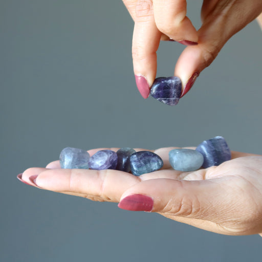 hand holding fluorite tumbled set