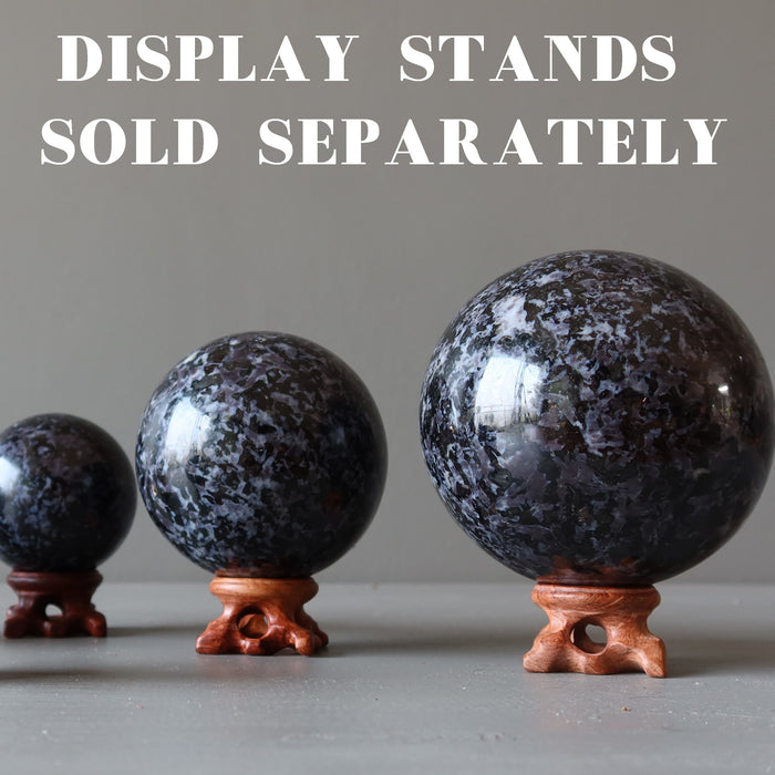 three Indigo Merlinite Gabbro Spheres on the wooden stands