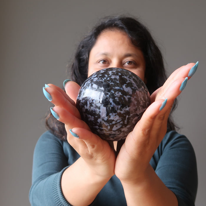 sheila of satin crystals holding Indigo Merlinite Gabbro Sphere