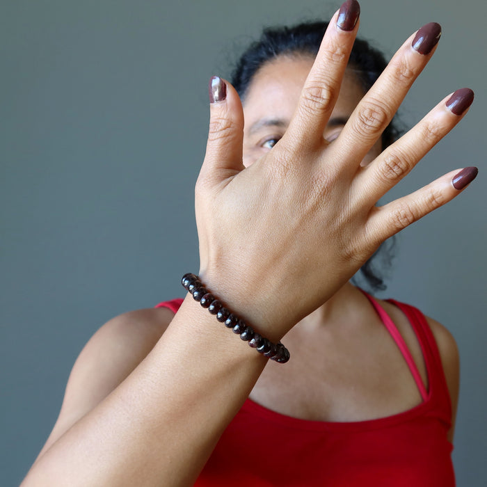 woman wearing red garnet rondelle bracelet