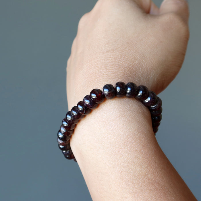red garnet rondelle bracelet on wrist