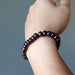 red garnet rondelle bracelet on wrist