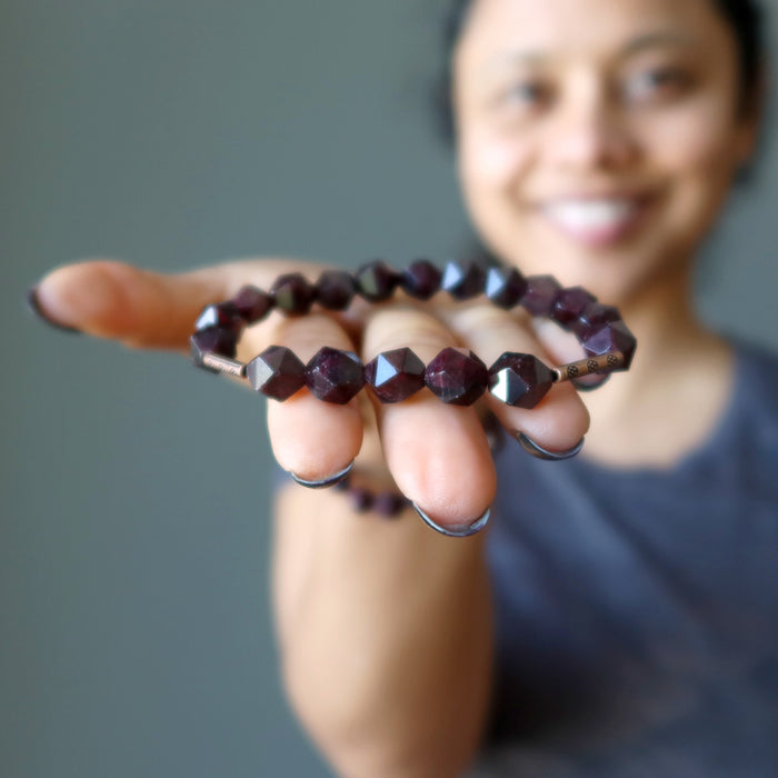 Sheila of Satin Crystals holding a Faceted Garnet Bracelet