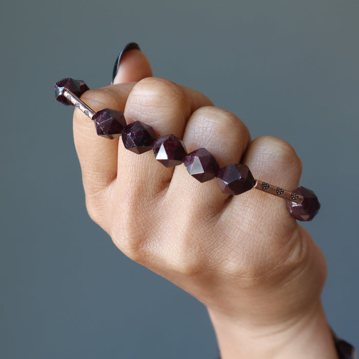 fisted hand with a Faceted Garnet Bracelet