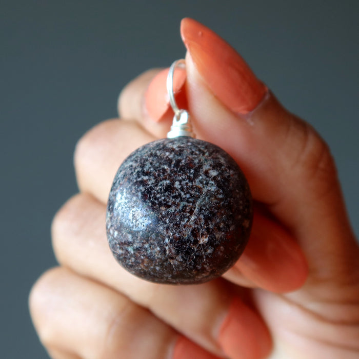 holding garnet nugget pendant