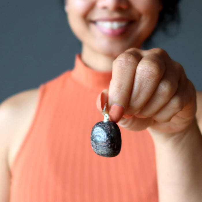sheila of satin crystals holding garnet nugget pendant