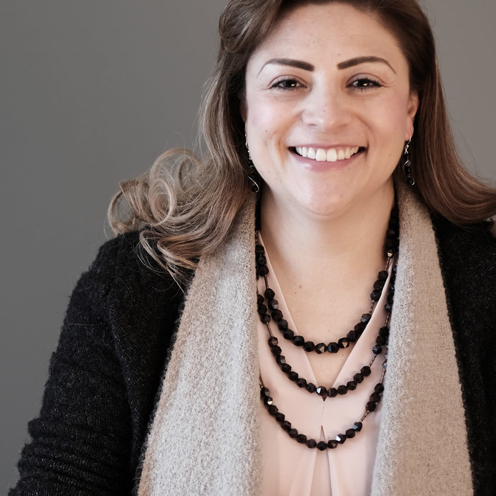 female model wearing three different length garnet necklaces 