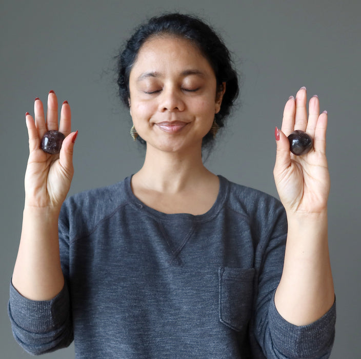 lady  meditating with garnet tumbled stones