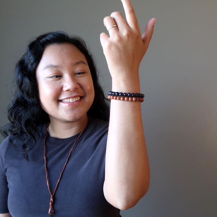 jessica of satin crystals admiring the goldstone bracelet set on her raised hand