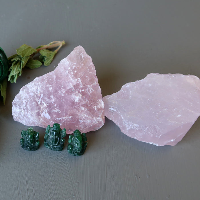 pair of rough pink rose quartz stones with three green aventurine ganesh